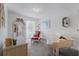 Bright room features neutral walls, desk, piano, chair, decor, and large windows for natural light at 7652 Mikasa Dr, Punta Gorda, FL 33950