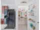 Bright pantry with wire shelving, providing ample storage space next to a stainless steel refrigerator at 7652 Mikasa Dr, Punta Gorda, FL 33950