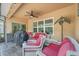 Outdoor patio features stylish wicker furniture, a ceiling fan, and a grill, perfect for entertaining at 7652 Mikasa Dr, Punta Gorda, FL 33950