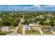 An aerial view showcases a well-maintained home in a lush, green neighborhood with mature trees at 891 Bayard St, Port Charlotte, FL 33948