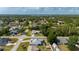 Expansive aerial view showcasing the neighborhood's lush greenery and the home's screened-in pool at 891 Bayard St, Port Charlotte, FL 33948