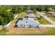 Elevated view of the home, highlighting the screened-in pool and backyard with an eye-catching roof at 891 Bayard St, Port Charlotte, FL 33948