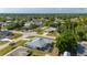High-angle view of the home featuring a well-maintained yard and a large, screened-in pool area at 891 Bayard St, Port Charlotte, FL 33948