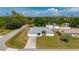 An aerial view of a well-maintained home nestled in a lush, green neighborhood with mature trees at 891 Bayard St, Port Charlotte, FL 33948