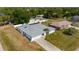 Aerial perspective of the home, featuring the driveway, landscaping, and screened-in pool at 891 Bayard St, Port Charlotte, FL 33948