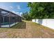 Fenced backyard featuring a screened in-ground pool, and ample green space at 891 Bayard St, Port Charlotte, FL 33948