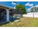 A fenced backyard featuring an outdoor screened enclosure with an in-ground swimming pool at 891 Bayard St, Port Charlotte, FL 33948