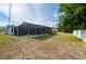 Backyard with fenced in pool, ample green space, and tree coverage at 891 Bayard St, Port Charlotte, FL 33948
