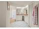 Traditional bathroom featuring a soaking tub, vanity with dual sinks, and a medicine cabinet at 891 Bayard St, Port Charlotte, FL 33948
