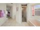 Hallway view into the bathroom with the glass-enclosed shower and soaking tub at 891 Bayard St, Port Charlotte, FL 33948