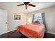 Cozy bedroom with a wooden ceiling fan, hardwood floors, and a window with a view at 891 Bayard St, Port Charlotte, FL 33948