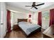 Bedroom with a dark-stained ceiling fan and dark-stained hardwood floors at 891 Bayard St, Port Charlotte, FL 33948