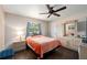 Cozy bedroom with a wooden ceiling fan, hardwood floors, and a dresser with a mirror at 891 Bayard St, Port Charlotte, FL 33948