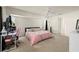 Bright bedroom featuring a ceiling fan, neutral carpet, and ample natural light for a comfortable living space at 891 Bayard St, Port Charlotte, FL 33948