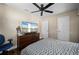 Cozy bedroom featuring a ceiling fan, dark wood dresser with a large television, and a comfortable bed at 891 Bayard St, Port Charlotte, FL 33948
