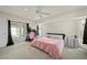 Spacious bedroom with a ceiling fan, neutral carpet, and a sliding glass door leading to the outdoor area at 891 Bayard St, Port Charlotte, FL 33948
