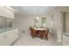 Cozy dining area features a charming table with seating for four, bathed in natural light from the surrounding windows at 891 Bayard St, Port Charlotte, FL 33948