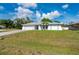 Charming one-story home with a two-car garage, beautiful landscaping, and a well-maintained lawn at 891 Bayard St, Port Charlotte, FL 33948