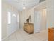 Inviting foyer with neutral tile flooring, decorative chest, and bright natural lighting at 891 Bayard St, Port Charlotte, FL 33948