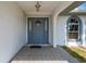 Front entrance featuring an arched entryway, a gray front door, sidelights, and tile floor at 891 Bayard St, Port Charlotte, FL 33948
