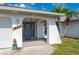 Front entrance featuring arched architecture and a slate gray front door and light fixture at 891 Bayard St, Port Charlotte, FL 33948