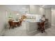 Bright eat-in kitchen with white cabinets, tile floors, and a breakfast bar for casual dining and entertainment at 891 Bayard St, Port Charlotte, FL 33948