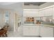 Clean kitchen with tile floors, white cabinetry, and view of the patio at 891 Bayard St, Port Charlotte, FL 33948