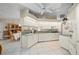 Bright kitchen featuring white cabinets, tile floors, and open to dining area at 891 Bayard St, Port Charlotte, FL 33948