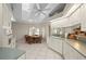 Bright eat-in kitchen featuring white cabinetry, tile floors, and a charming breakfast nook with large windows at 891 Bayard St, Port Charlotte, FL 33948