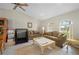 Comfortable living room featuring tile flooring, neutral decor, and sun-filled windows at 891 Bayard St, Port Charlotte, FL 33948