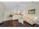 Open floor plan featuring a living room with hardwood floors connecting to a bright and airy eat-in kitchen area at 891 Bayard St, Port Charlotte, FL 33948