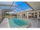 Inviting in-ground pool with a screened enclosure, offering a private backyard and outdoor entertaining space at 891 Bayard St, Port Charlotte, FL 33948