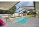 Sparkling in-ground pool with screened enclosure; ideal for refreshing swims and outdoor recreation at 891 Bayard St, Port Charlotte, FL 33948