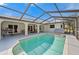 Well-maintained in-ground pool with screened enclosure; showcasing an inviting backyard and relaxing outdoor space at 891 Bayard St, Port Charlotte, FL 33948