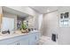 Well-lit bathroom featuring a double vanity, a tiled shower, and modern fixtures at 9710 Sand Dune Ln, Punta Gorda, FL 33950
