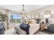 Bright, stylish bedroom featuring a large window view, modern decor, and a cozy, inviting atmosphere at 9710 Sand Dune Ln, Punta Gorda, FL 33950