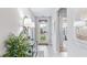 Bright entryway with stylish decor, a glass console table, and a clear view to the front door at 9710 Sand Dune Ln, Punta Gorda, FL 33950