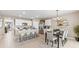 Bright, open kitchen with an island, stainless steel appliances, and a combined dining area for easy entertaining at 9710 Sand Dune Ln, Punta Gorda, FL 33950