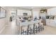 Stylish kitchen with white cabinets, an island with seating, and stainless steel appliances at 9710 Sand Dune Ln, Punta Gorda, FL 33950