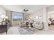Comfortable living room featuring a ceiling fan, neutral tones, and a large window offering scenic views at 9710 Sand Dune Ln, Punta Gorda, FL 33950