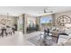 Open-concept living space with dining area and living room featuring large windows and modern decor at 9710 Sand Dune Ln, Punta Gorda, FL 33950