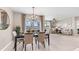 Expansive open living area with a dining table and a living room that features a large window with outdoor views at 9710 Sand Dune Ln, Punta Gorda, FL 33950