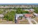 An aerial view of a home featuring a pool, a large RV parked in the driveway, and mature trees on a sunny day at 10229 Gulfstream Blvd, Englewood, FL 34224