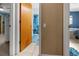 Hallway view into bathroom featuring a shower with patterned shower curtain, and bathmat at 10229 Gulfstream Blvd, Englewood, FL 34224