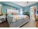 Comfortable and serene main bedroom with an ensuite bathroom, nautical decor, and ample light at 10229 Gulfstream Blvd, Englewood, FL 34224