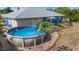 Enjoy this backyard oasis with an above-ground pool, swing set, and lush greenery for serene outdoor living at 10229 Gulfstream Blvd, Englewood, FL 34224