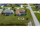Aerial shot of home showing the pool, landscaping, neighboring houses and canal access at 1 Sportsman Cir, Rotonda West, FL 33947