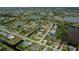 Beautiful aerial view of a residential community featuring waterfront homes and well-maintained landscaping near a lake at 1 Sportsman Cir, Rotonda West, FL 33947