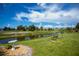 Scenic backyard with a tranquil canal view, featuring a charming bench and decorative bird bath at 1 Sportsman Cir, Rotonda West, FL 33947