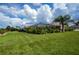 Spacious backyard featuring a screened-in lanai and mature landscaping, ideal for outdoor living and privacy at 1 Sportsman Cir, Rotonda West, FL 33947